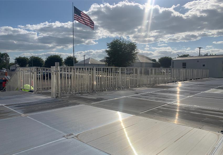 This image is of an installation of EZ Access Commercial Ramps with and American flag in the background